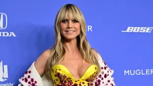 Heidi Klum showcases her breasts named Hans and Franz in a yellow mini dress at an event in 2023