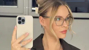Dagi Bee with glasses and hair pinned up takes a mirror selfie of himself in January 2023