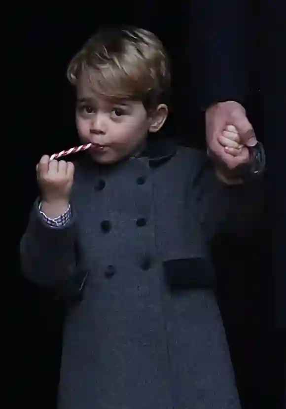 Prinz George von Cambridge isst eine Süßigkeit, als er nach dem Gottesdienst in der St Mark's Church am Weihnachtstag am 25. Dezember 2016 abreist
